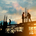 Silhouette of engineer and construction team working at site ove